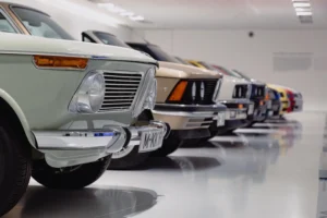 A lineup of classic luxury cars parked