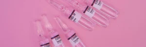 Empty medical syringes on a pink background