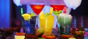 Colorful arrangement of three alcoholic drinks on a bar