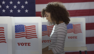 Black Gen Z woman voting in an election