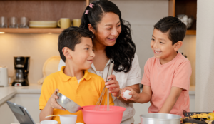 Hispanic mom cooking with her two Gen Alpha sons