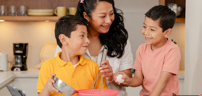 Hispanic mom cooking with her two Gen Alpha sons