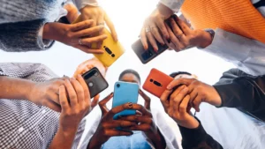 A view from the bottom of hands holding phones