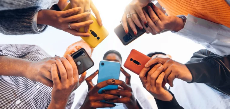 A view from the bottom of hands holding phones