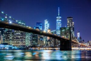 Nighttime view of New York City over the water