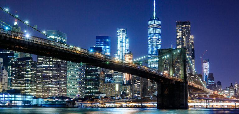 Nighttime view of New York City over the water